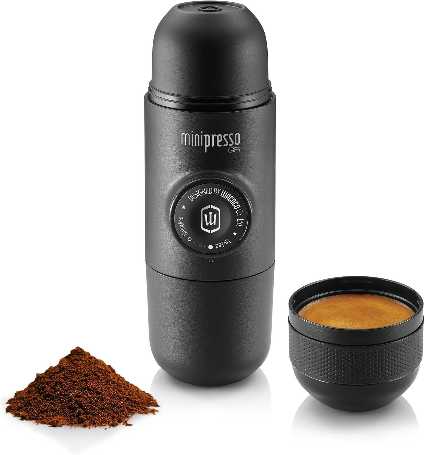 Wacaco Minipresso GR handheld espresso maker with ground coffee outdoors